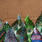 Biodegradable Shoes - a group of colorful paper flowers sitting on top of a table