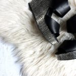 Shoes Painlessly - pair of women's black-and-gray wedges on white fur textile