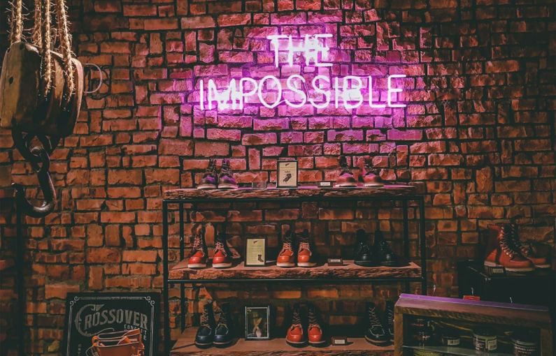 Classic Shoes - The Impossible neon light signage on brick wall