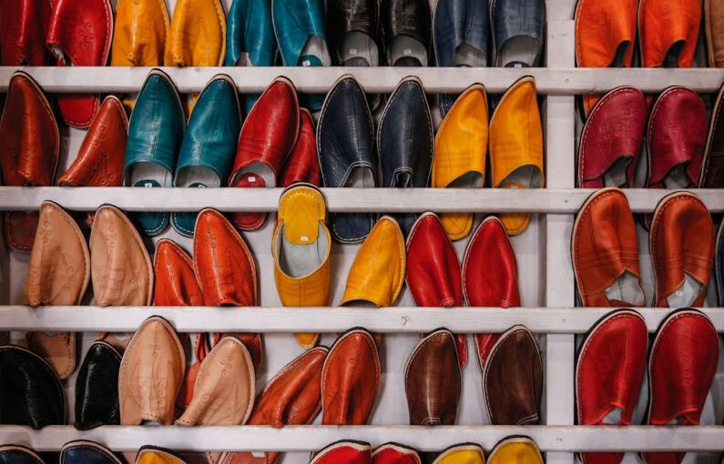 Shoe Craftsmanship - assorted-color shoe lot on white wooden shelf