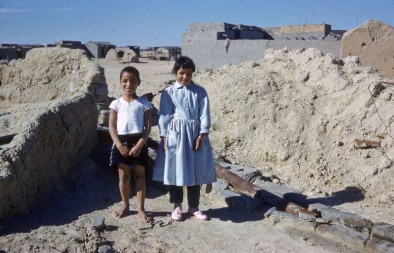 Archaeological Footwear - 2 women standing on gray sand during daytime