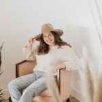 Shoe Sizes - woman in white long sleeve shirt and gray pants sitting on brown wooden seat